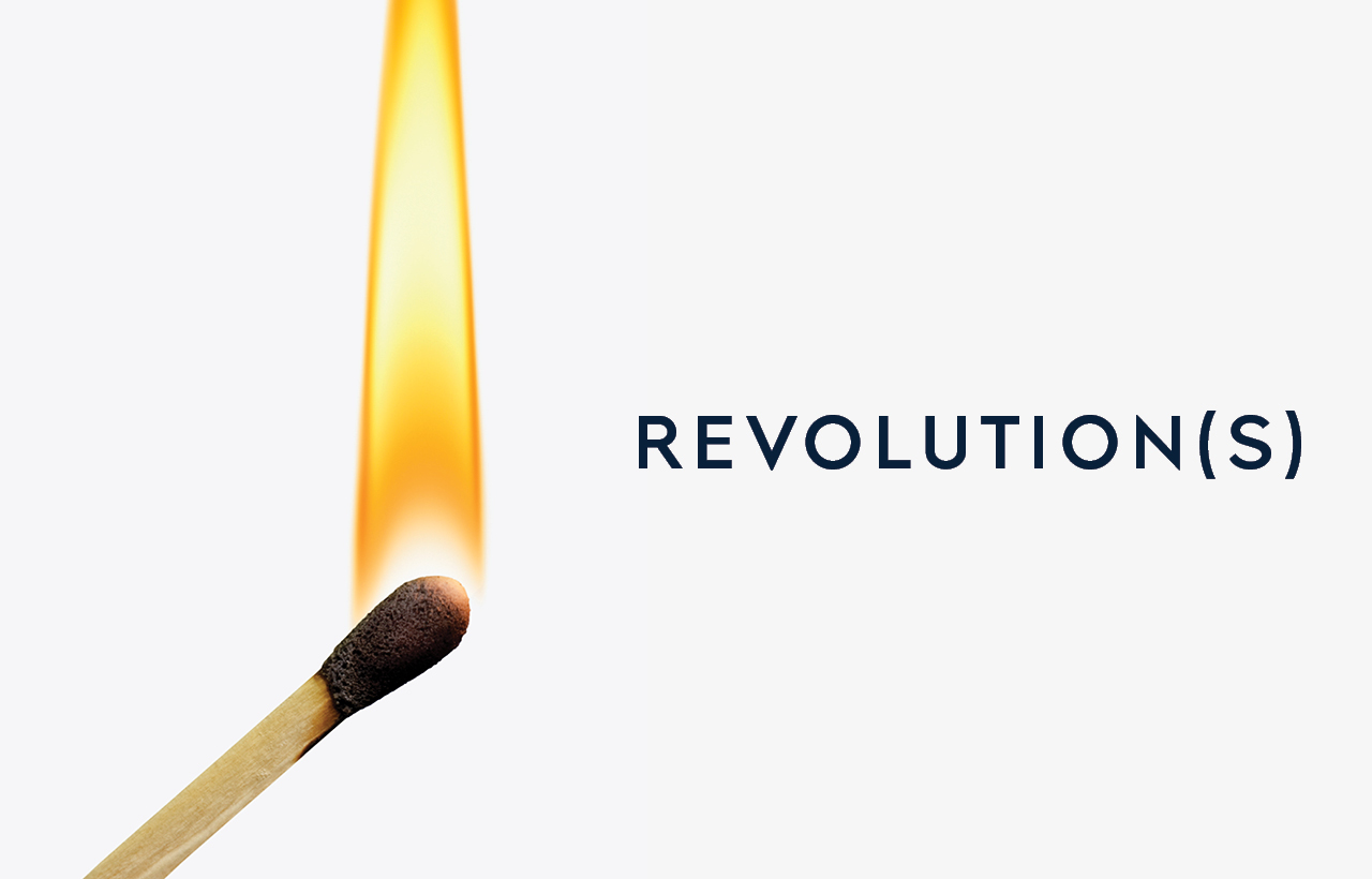 A golden yellow flame, outlined in orange, rises up from the head of a lit wooden match.