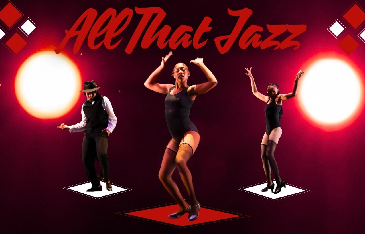 Three dancers performing in black dance costumes on a stage with dramatic red and white spotlights and geometric diamond accents.