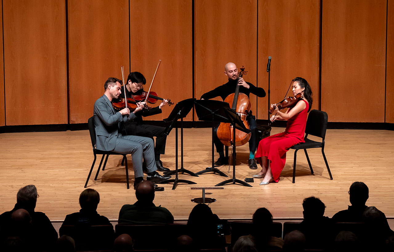 Dover Quartet performing seated on the Pick-Staiger Concert Hall stage