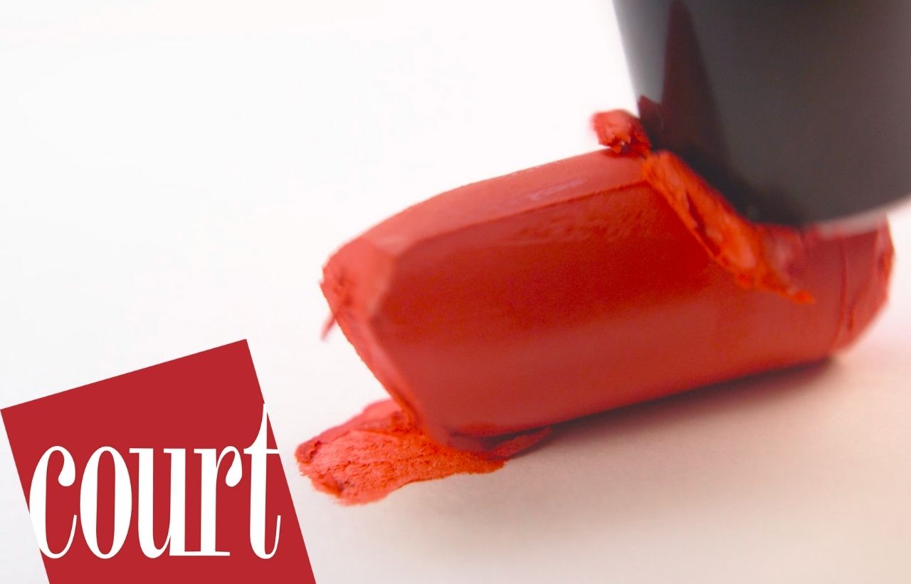 A tube of lipstick being pushed down.